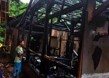 KEBAKARAN–Warga sedang membantu membereskan rumah yang terbakar, di Kampung Kadubetus, Desa Kawoyang, Kecamatan Carita, Kabupaten Pandeglang, Selasa (14/9/2021). (ISTIMEWA)