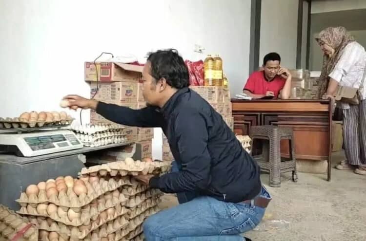 HARGA TELUR MELAMBUNG–Pembeli sedang memilah telur ayam, yang bakal dibelinya, di salah satu penjual telur di Pasar Badak Pandeglang. (DOKUMEN/SATELITNEWS.COM)