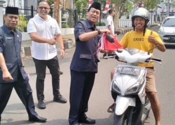 Sekretariat Dewan (Sekwan) Pandeglang dan jajarannya, bagikan bendera ke pengguna jalan di sekitaran Gedung DPRD setempat, Rabu (9/8/2023). (FAHRIE/SATELITNEWS.COM)