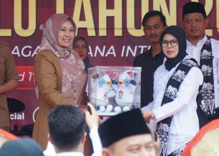 Ketua KPU Pandeglang Nur Azizah (kanan), serahkan simbol Pemilu 2024 ke Bupati Pandeglang Irna Narulita, di acara Kirab Pemilu 2024, di Alun-alun setempat, Senin (11/9/2023). (ISTIMEWA)