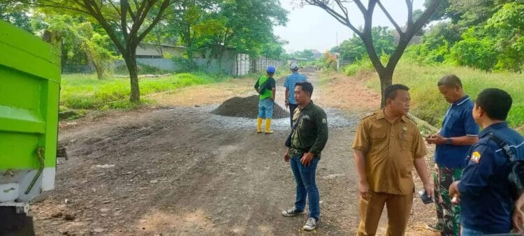 Ketua Forum RT/RW Kota Serang, tengah memantau proses pembangunan jalan di SDN Cilampang, Senin (1/7/2024). (SIDIK/SATELITNEWS.COM)