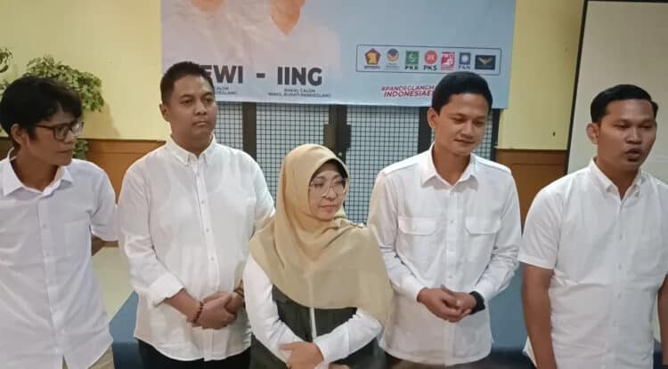 Pasangan Balon Bupati dan Wakil Bupati, Dewi - Iing, diapit Ketua Tim Pemenangan dan Jubir, dalam sebuah acara. (ISTIMEWA)