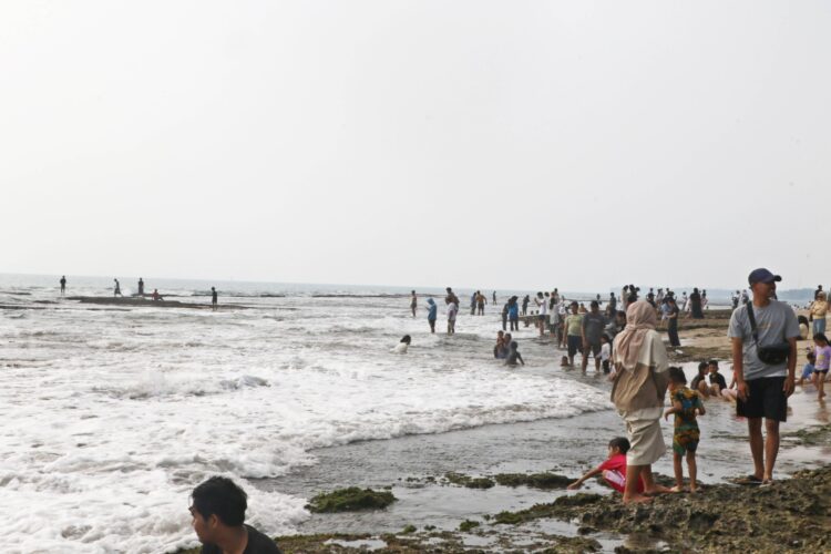 PADAT PENGUNJUNG - Wisatawan memenuhi kawasan wisata Pantai Anyer, Kabupaten Serang, beberapa waktu lalu. (ISTIMEWA)